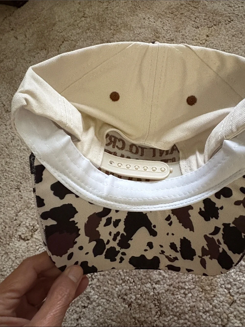 Embroiled Cream and Brown Cow Print Trucker Hat with Bold Quote